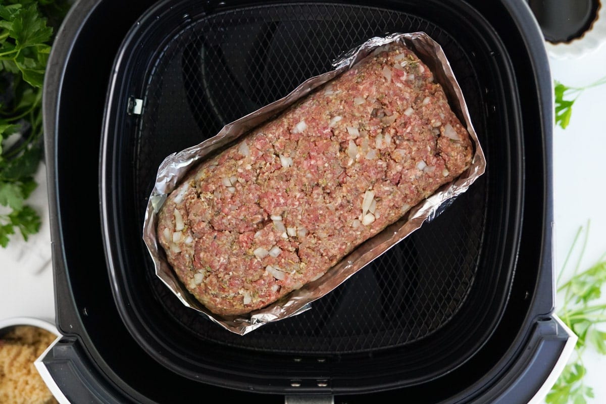 meatloaf wrapped in foil in air fryer basket