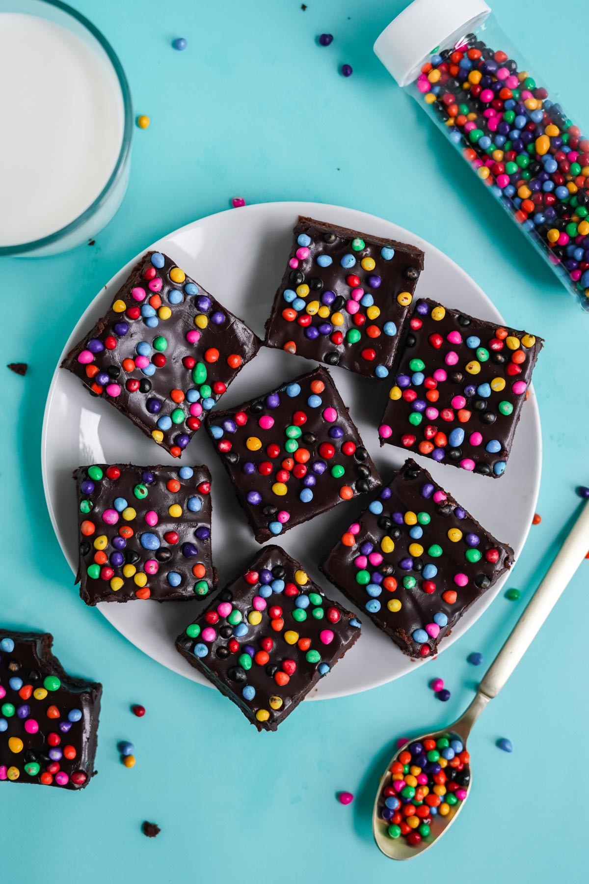 cosmic brownies with sprinkles on a white plate