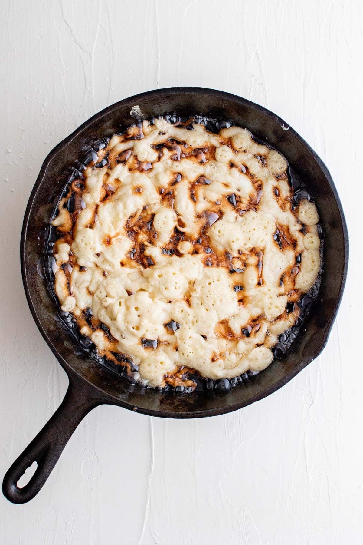 funnel cake batter in a frying pan