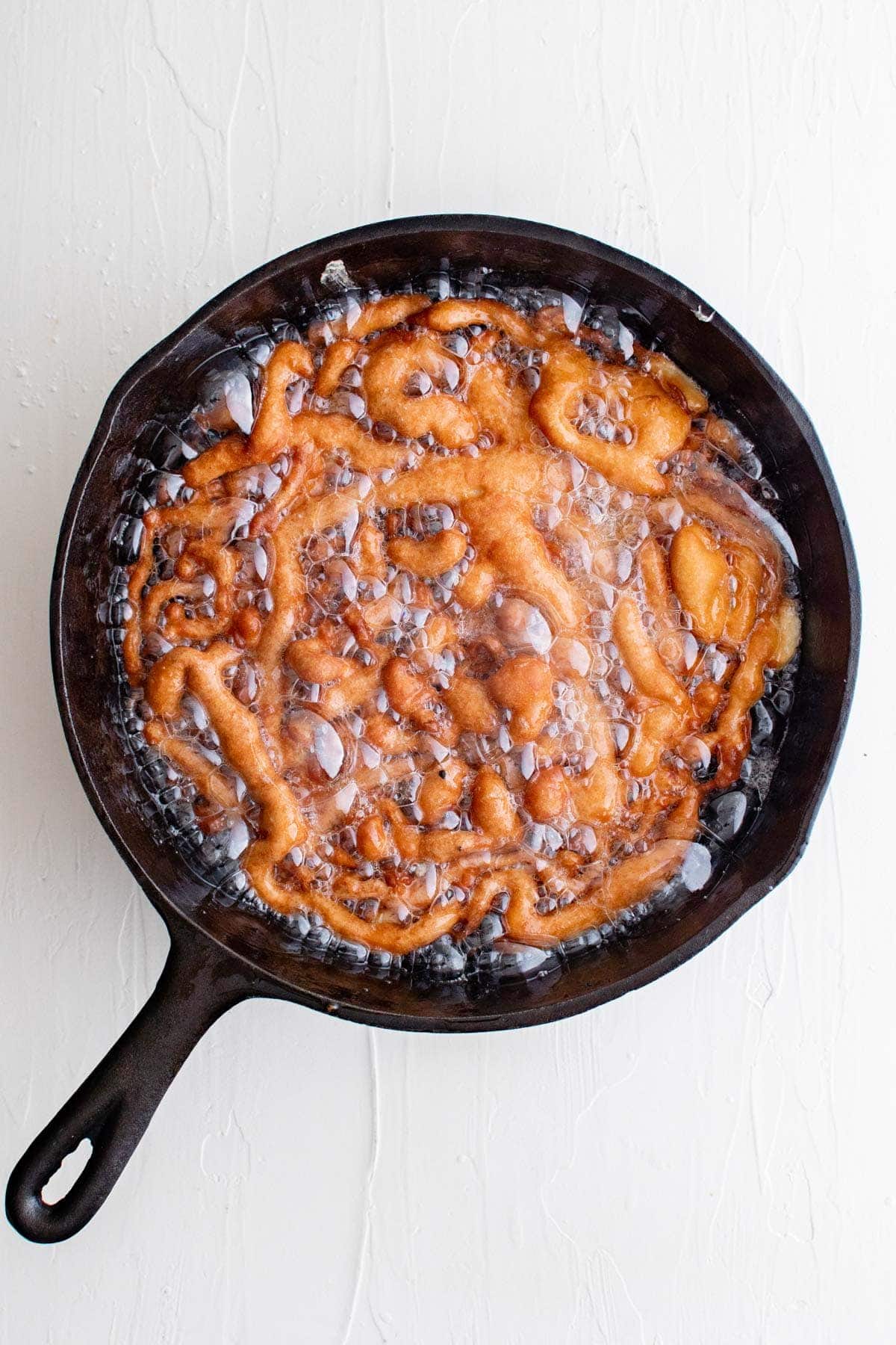 funnel ake frying in a large skillet