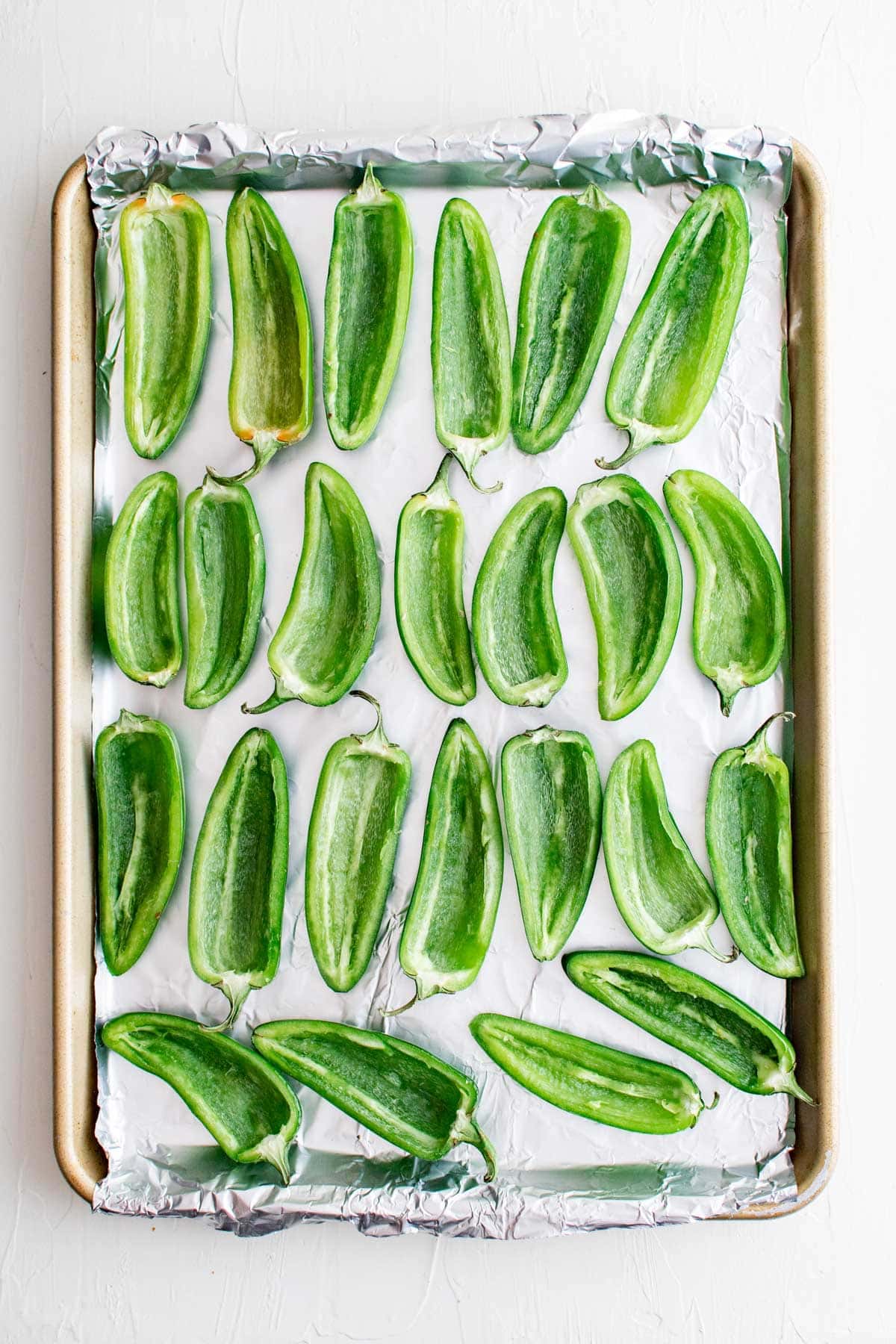 jalapeno halves on a baking tray