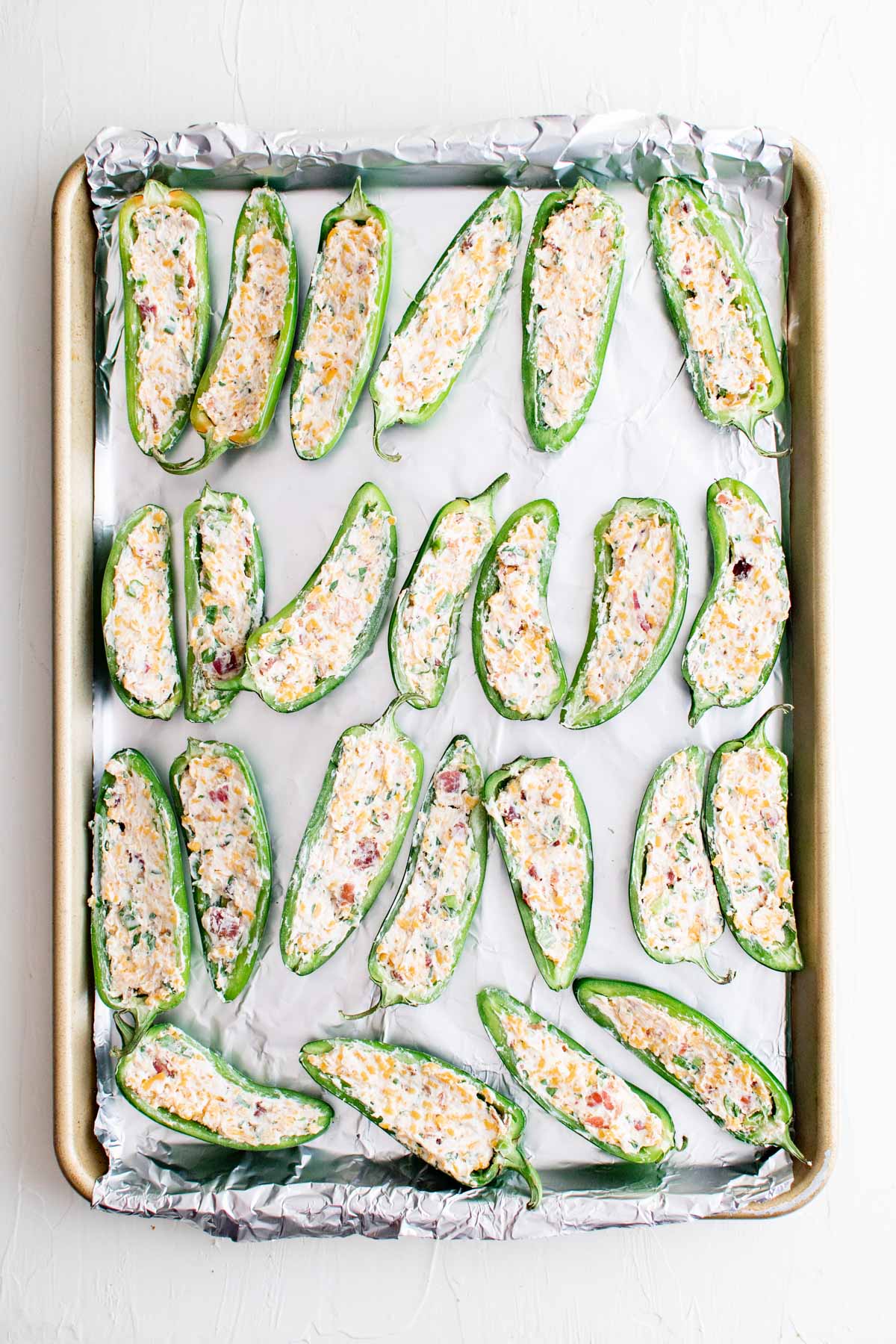 jalapeno popper with filling on a baking tray