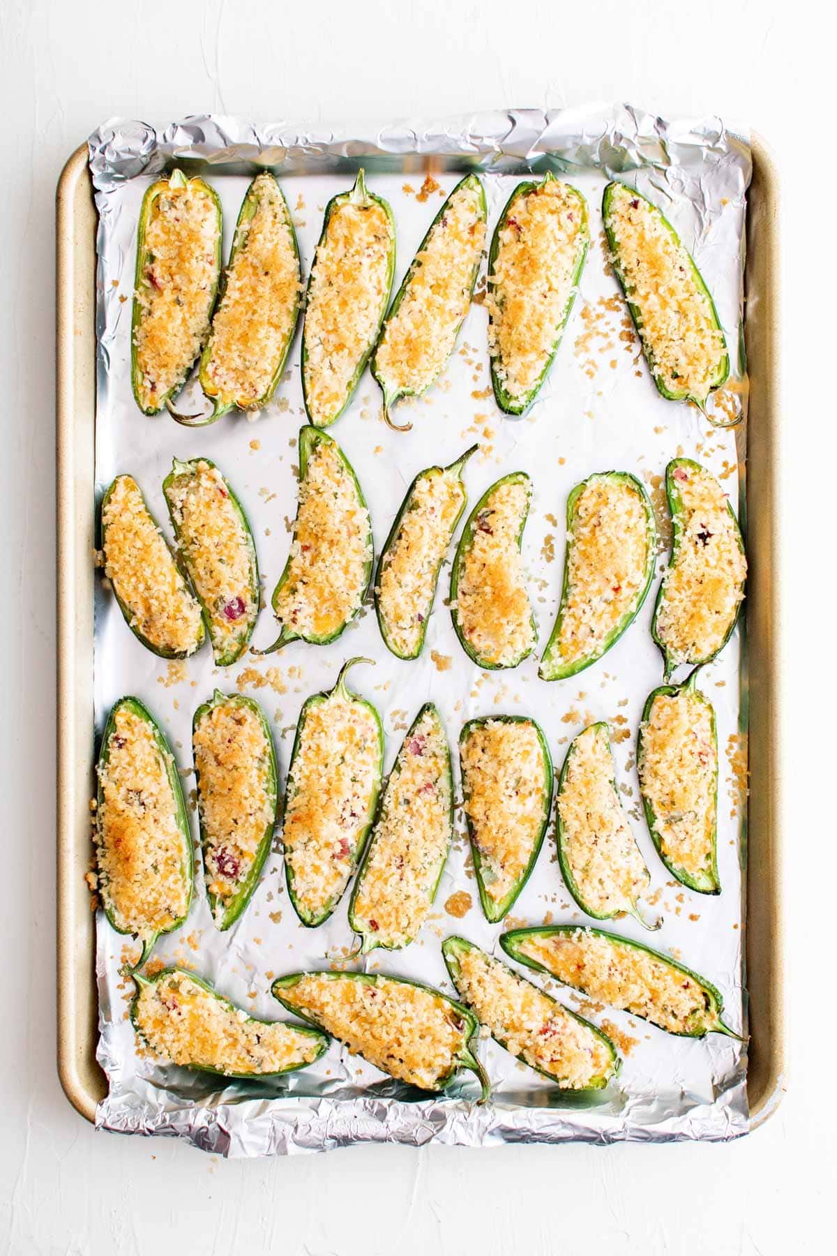baked jalapeno poppers on baking sheet