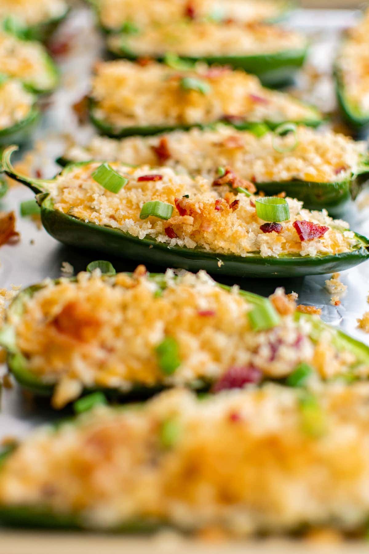 jalapeno halves with breadcrumbs on top and parsley
