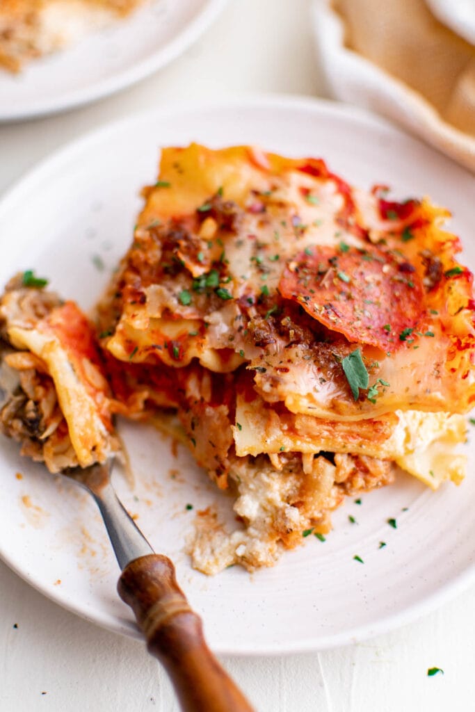 lasagna on a white plate and a fork