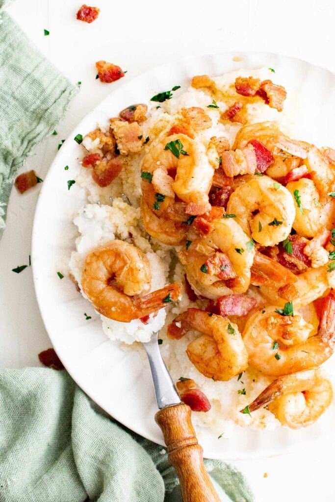 shrimp, grits, white plate, fork, green napkin