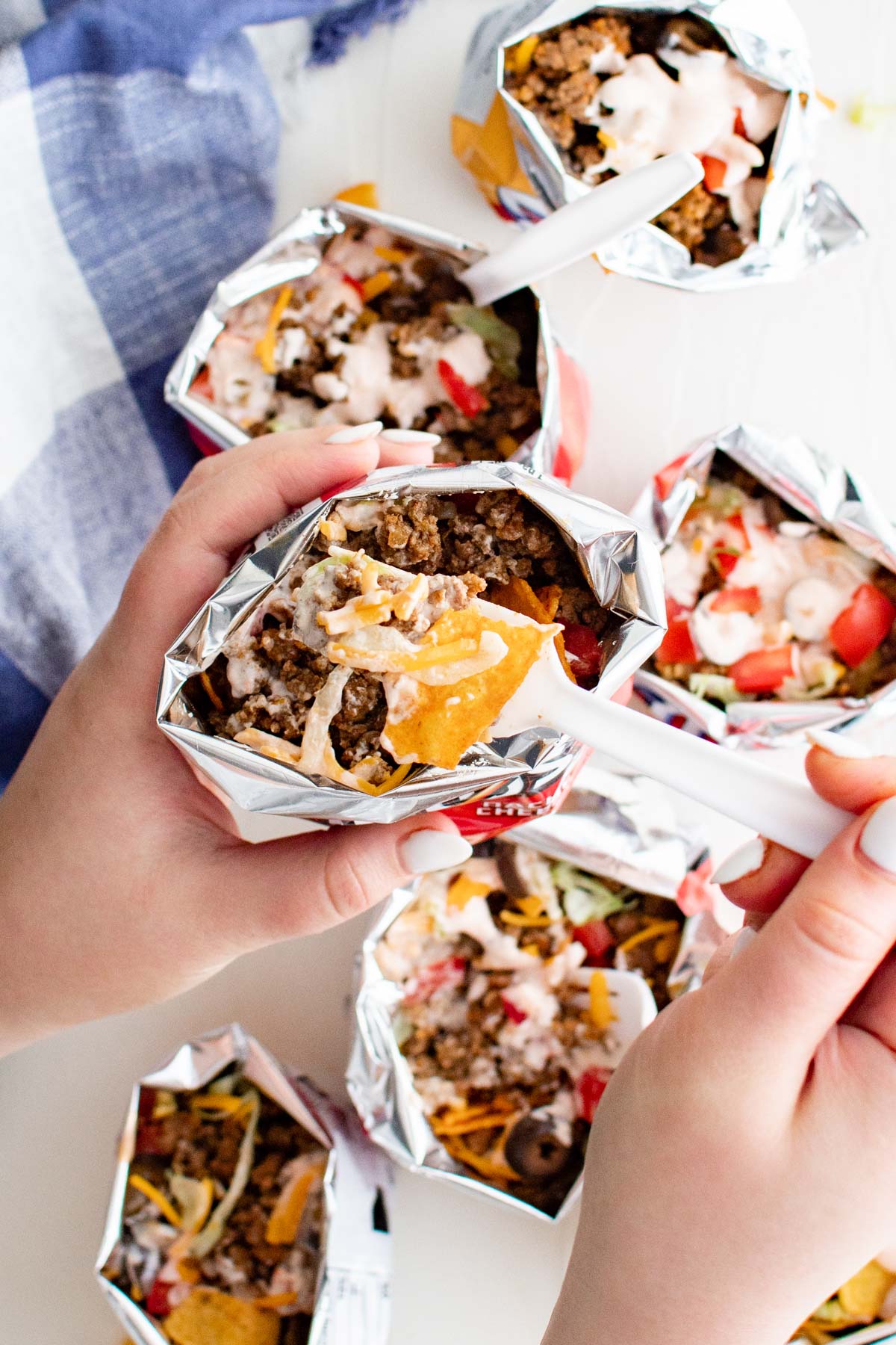 chip bags, hands holding a bag with taco meat, cheese