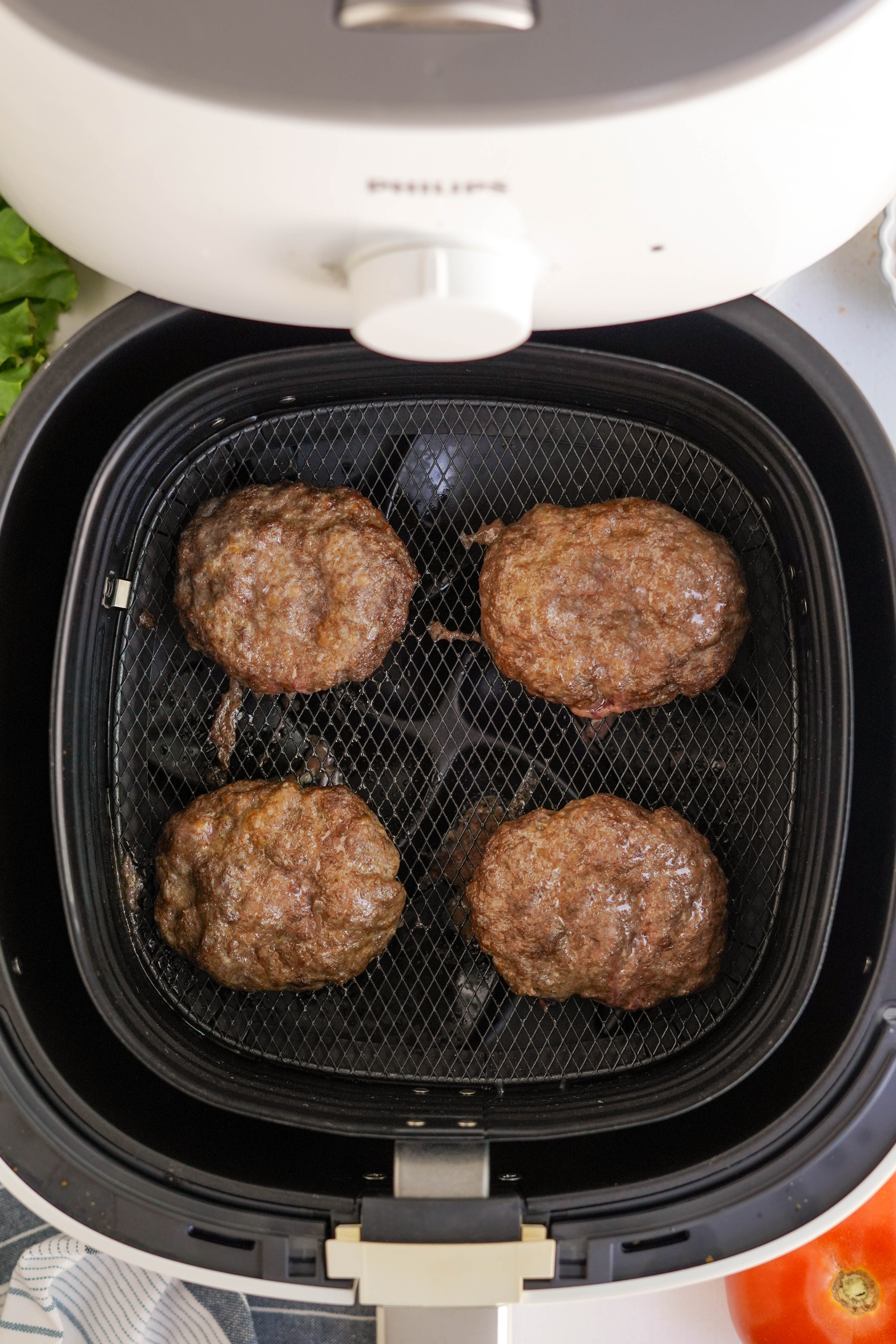 cooked hamburgers in air fryer basket