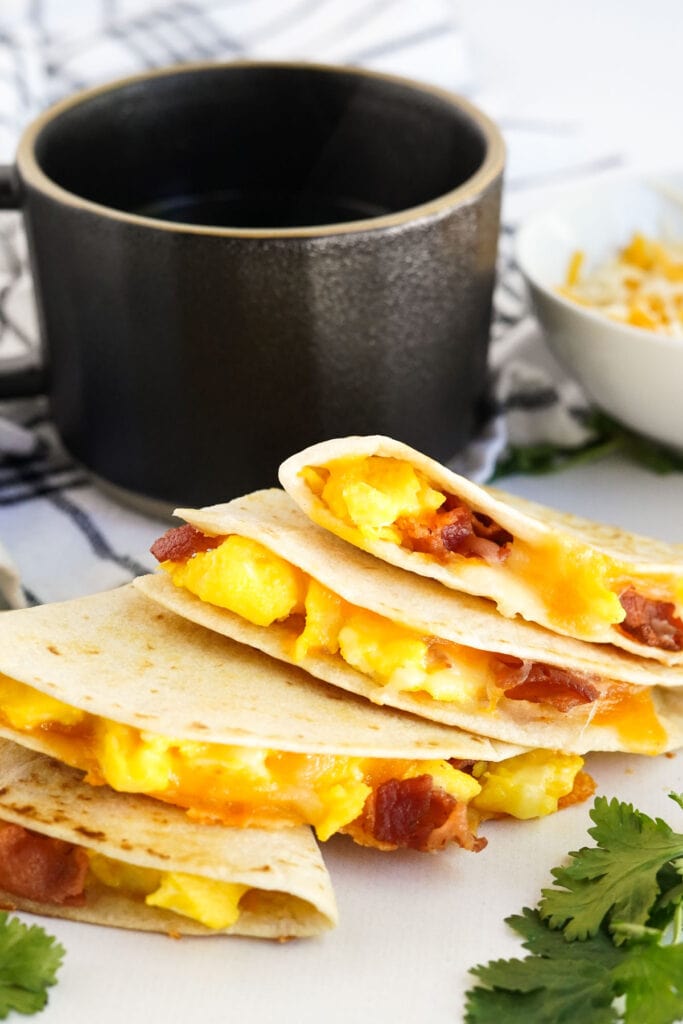 slices of breakfast quesadilla and cup of coffee