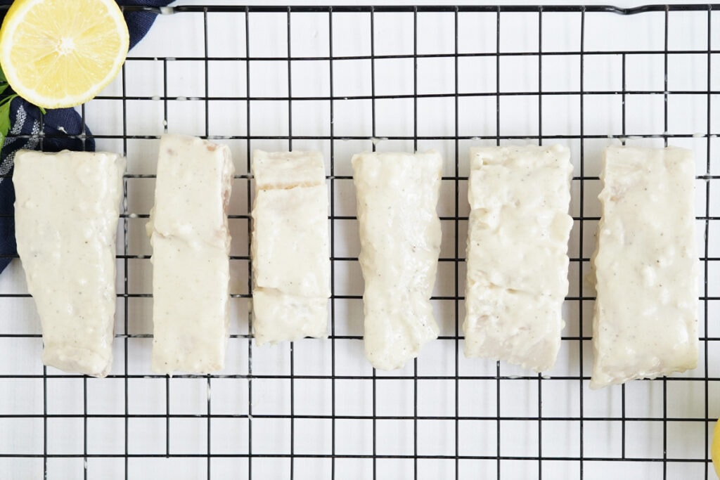 battered fish pieces on a wire rack