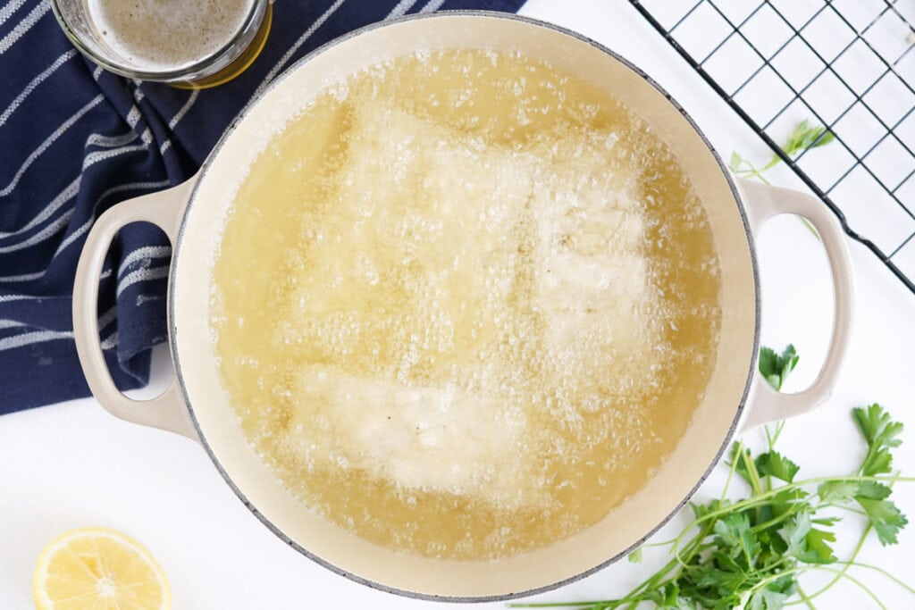 large pot with frying oil and fish