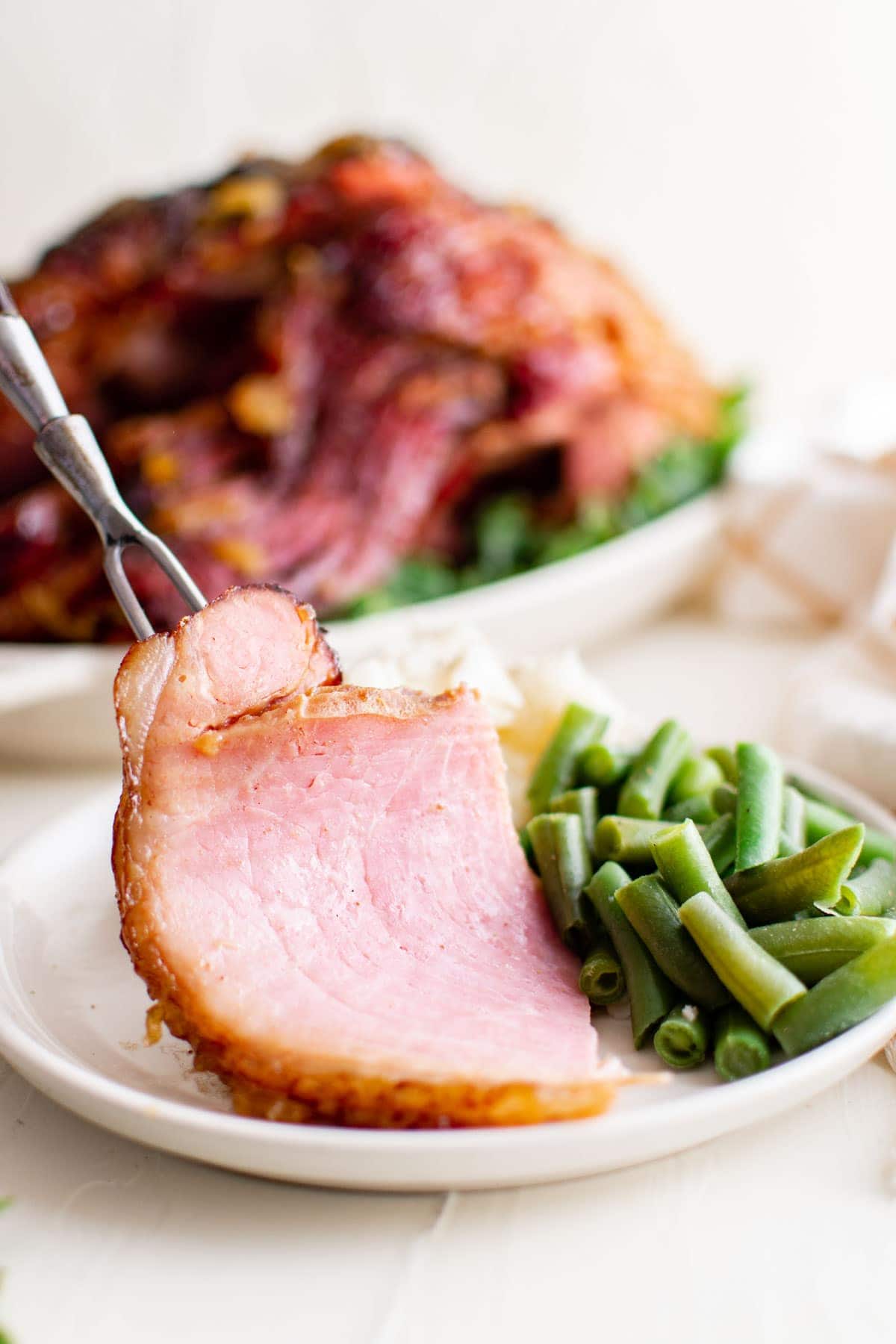 ham and green beans on a white plate