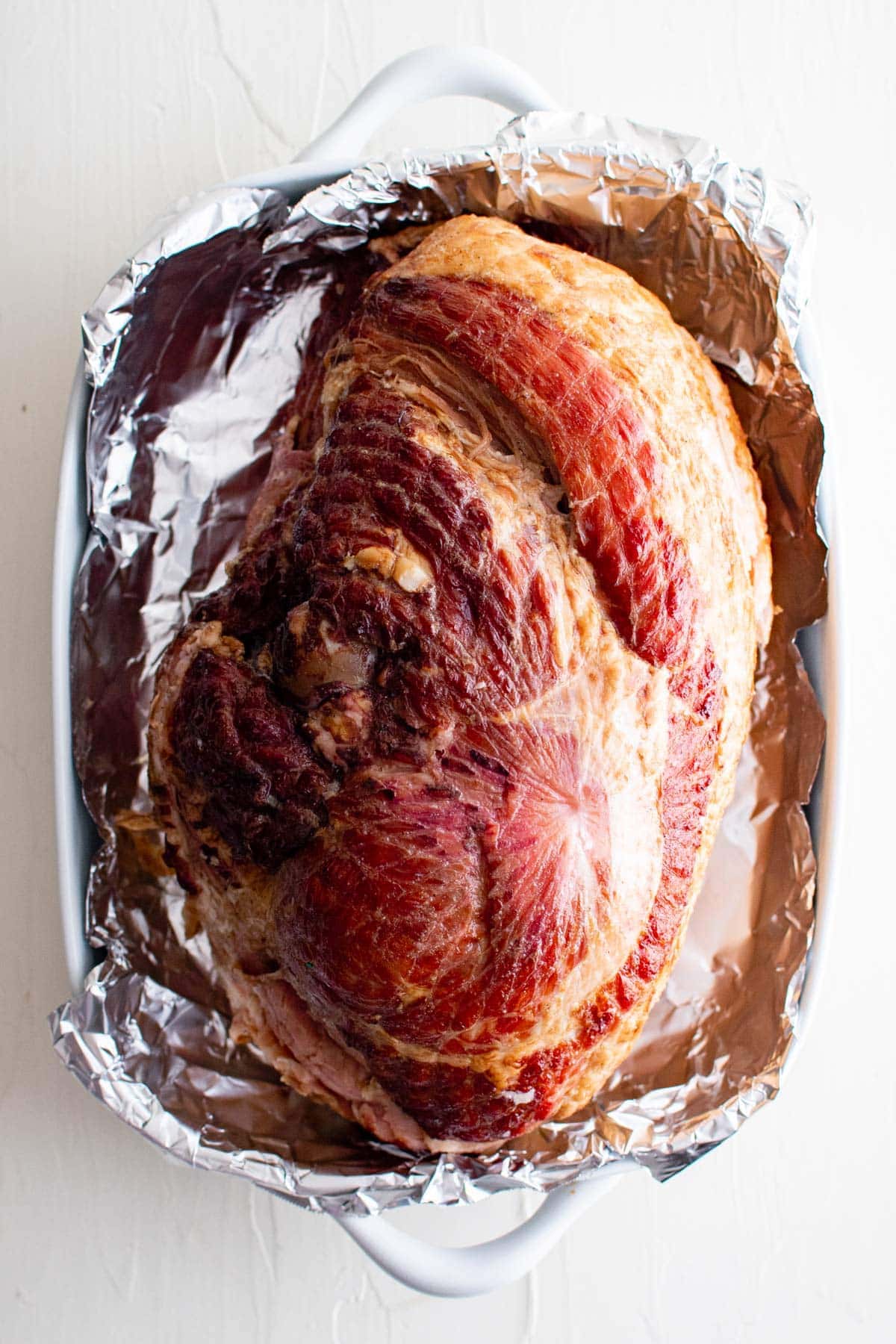 bone in ham in a foil lined baking dish