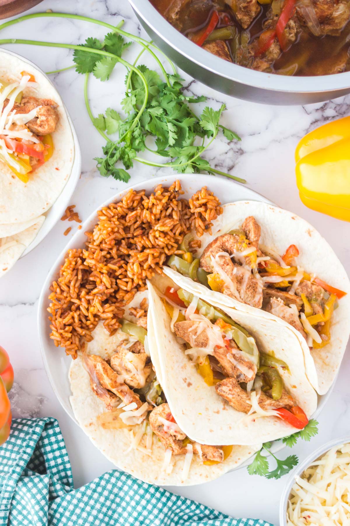 chicken fajitas and rice on a white plate