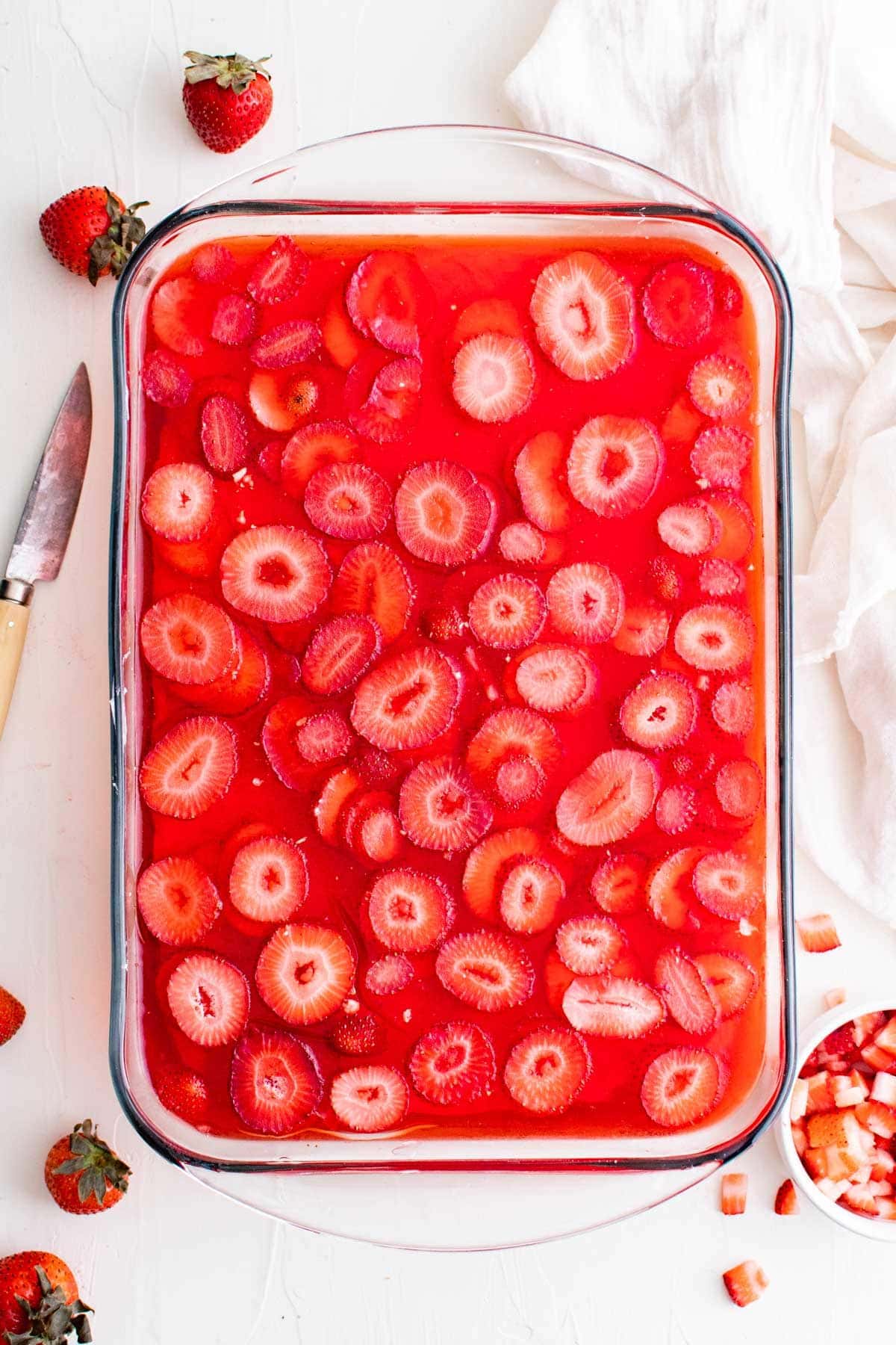 overhead shot of strawberry jello salad in baking dish