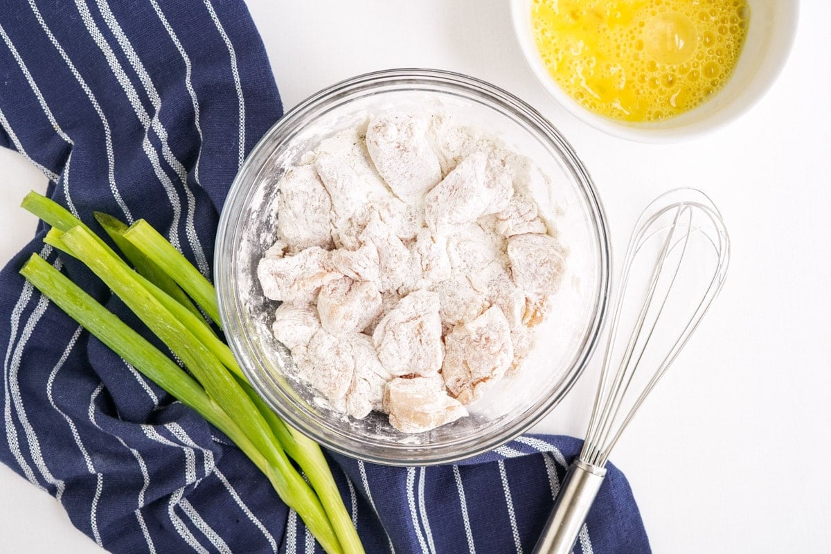 chicken pieces coated in egg and flour, on a wire rack