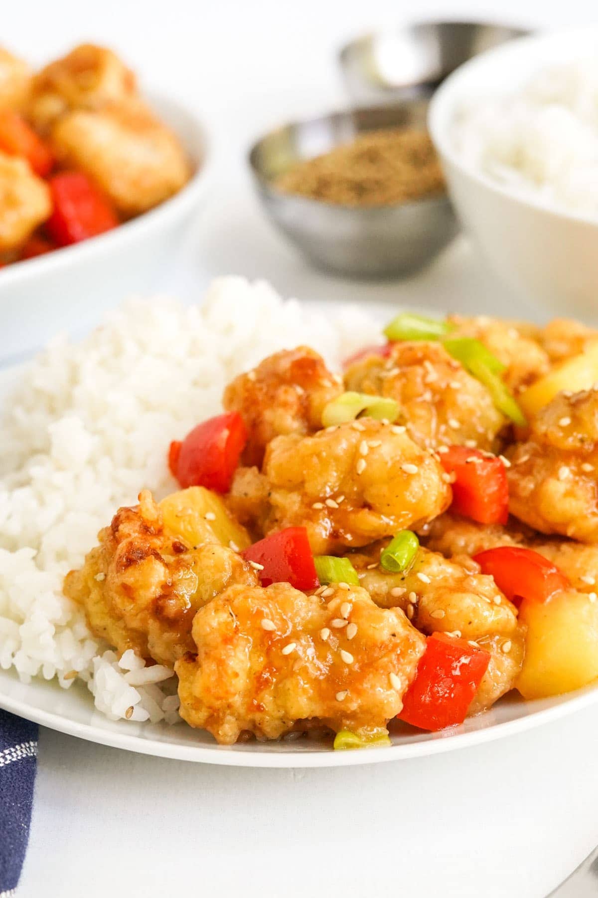 sweet and sour chicken with rice on a plate