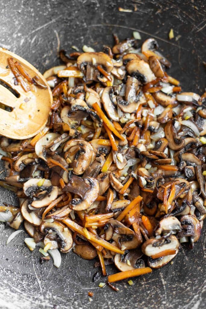 carrots and mushrooms in a skilelt