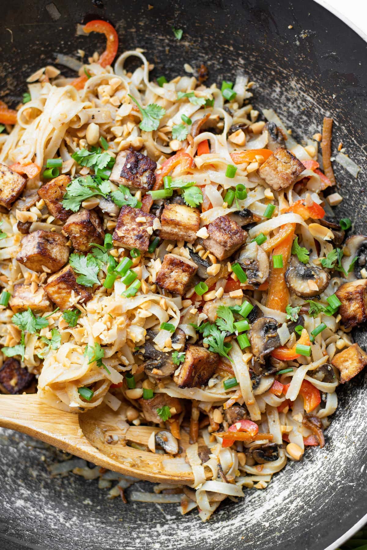 pad thai noodles with vegetables and tofu in a skillet