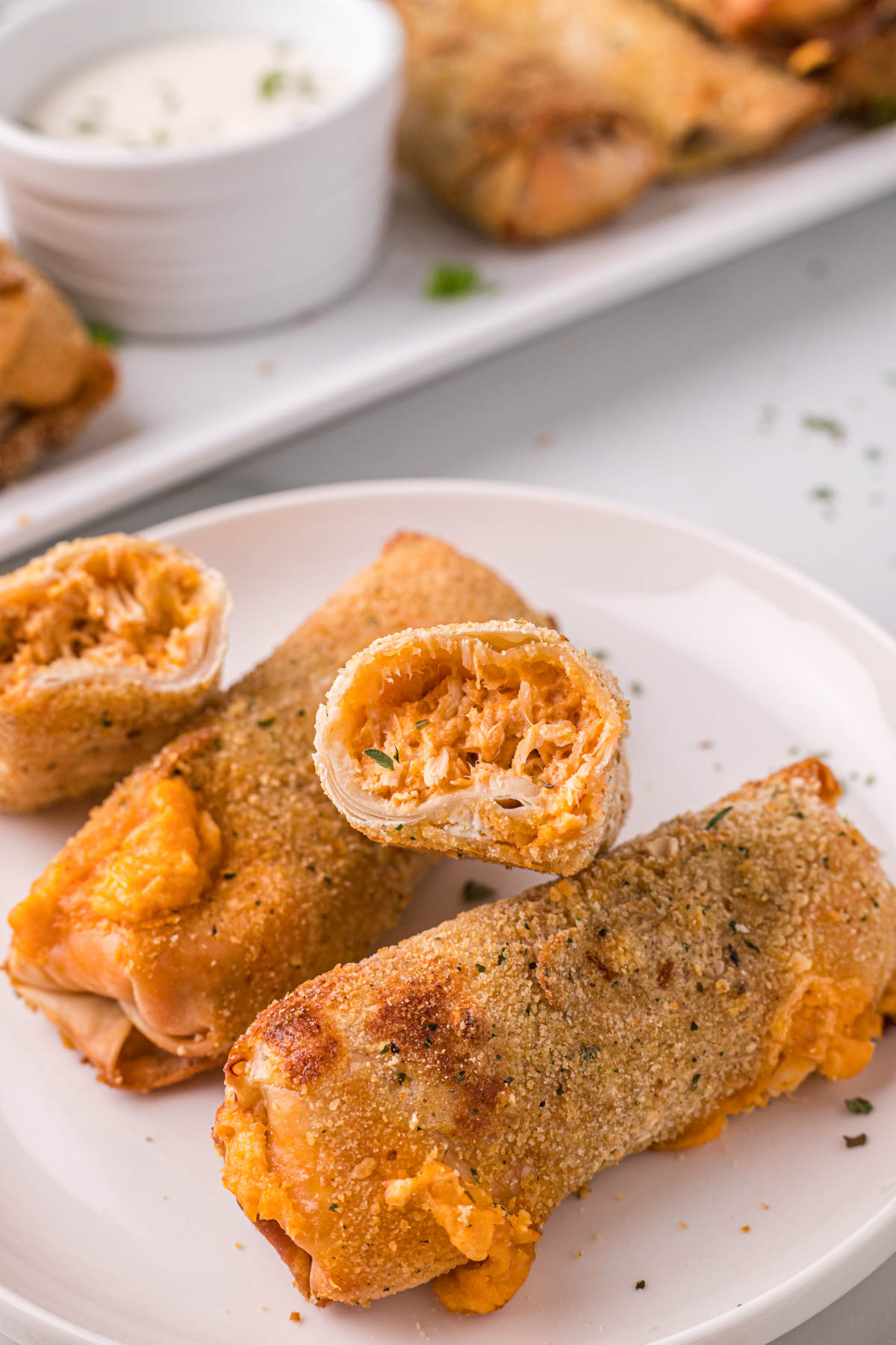 buffalo chicken egg rolls cut in half to show the filling