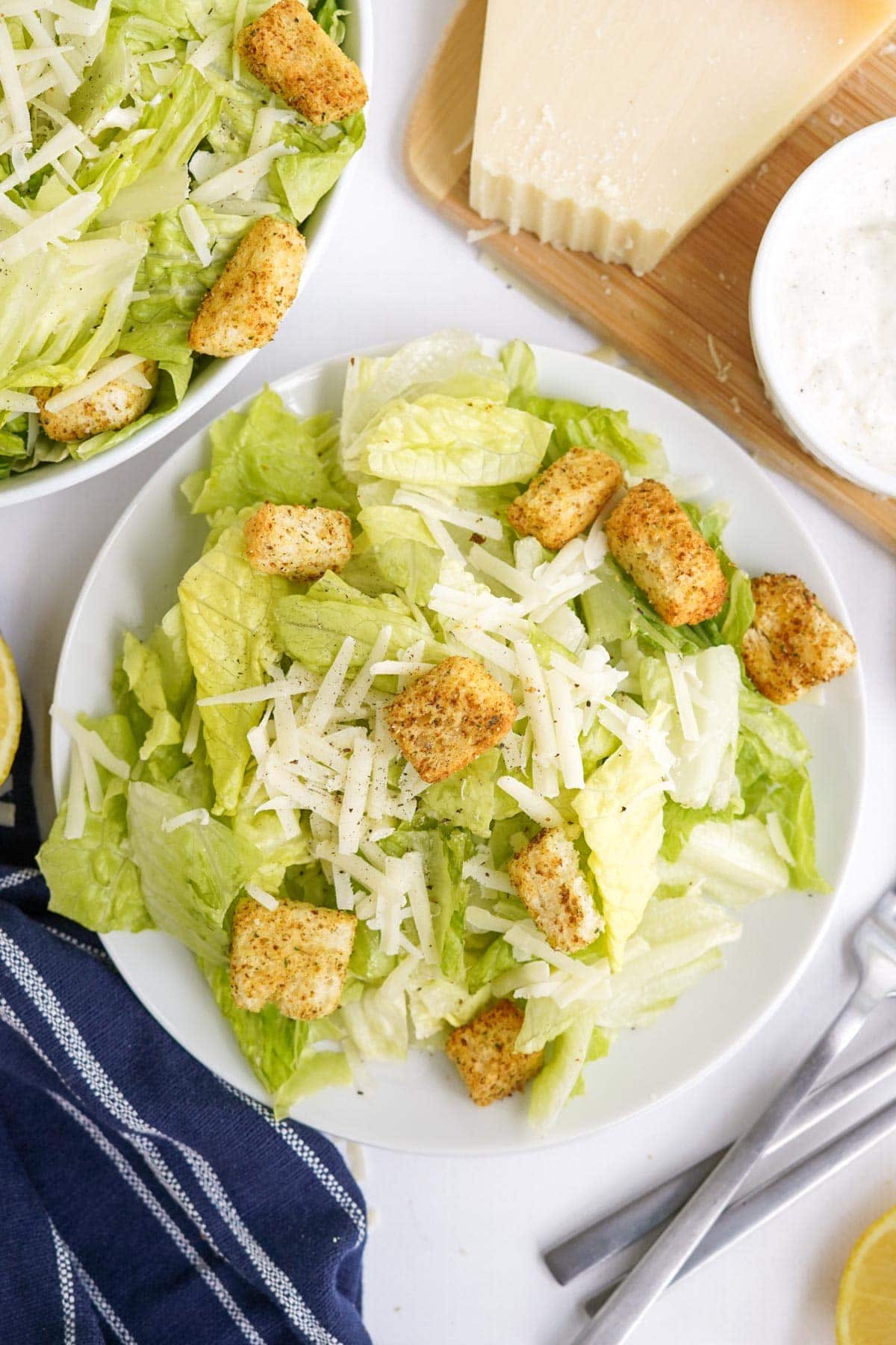 caesar salads on white plates