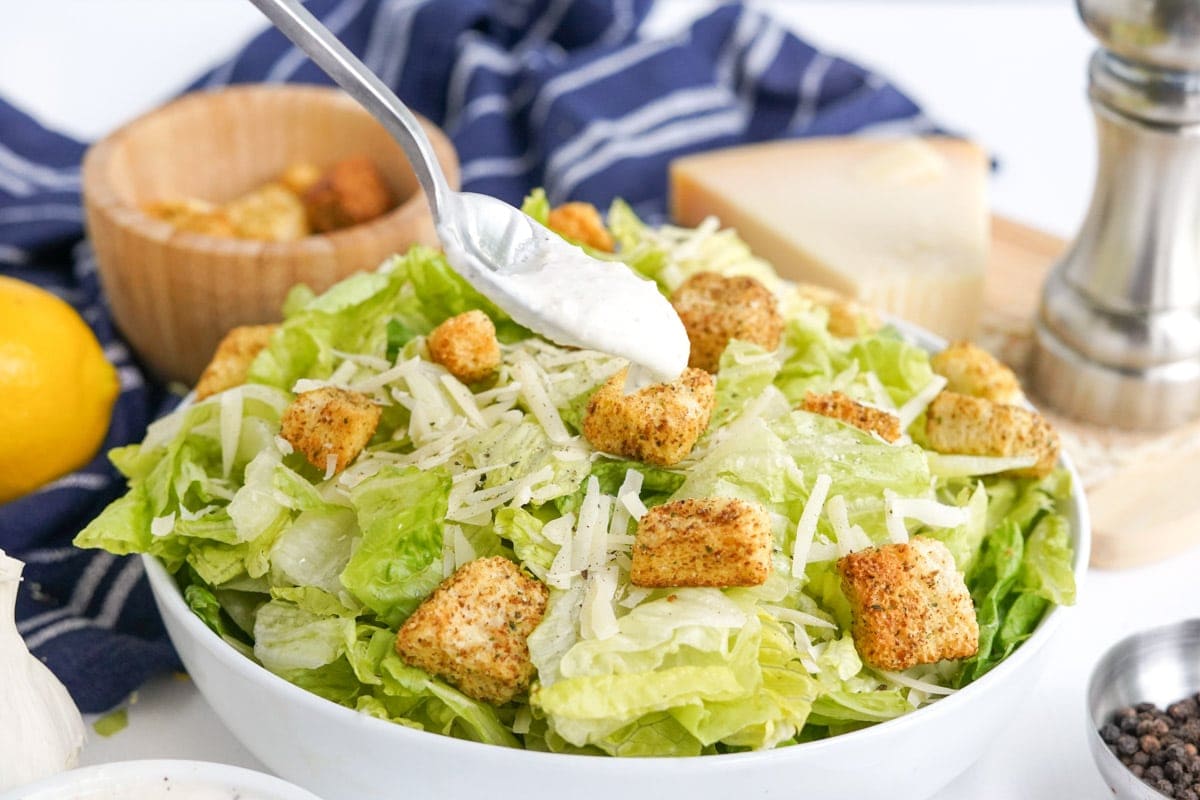 salad with croutons, spoon with dressing