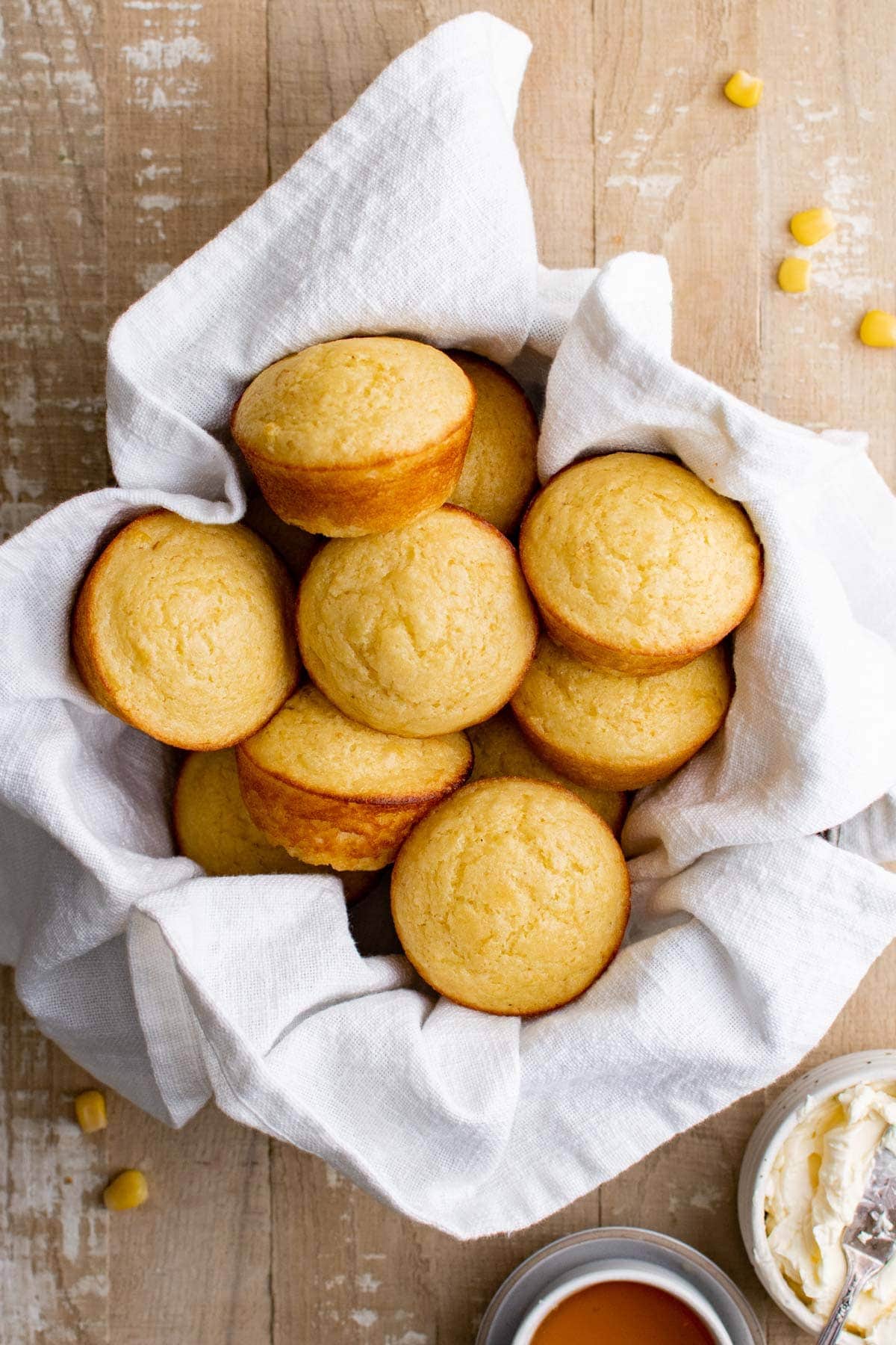 basket with a white towel filled with cornbread muffins