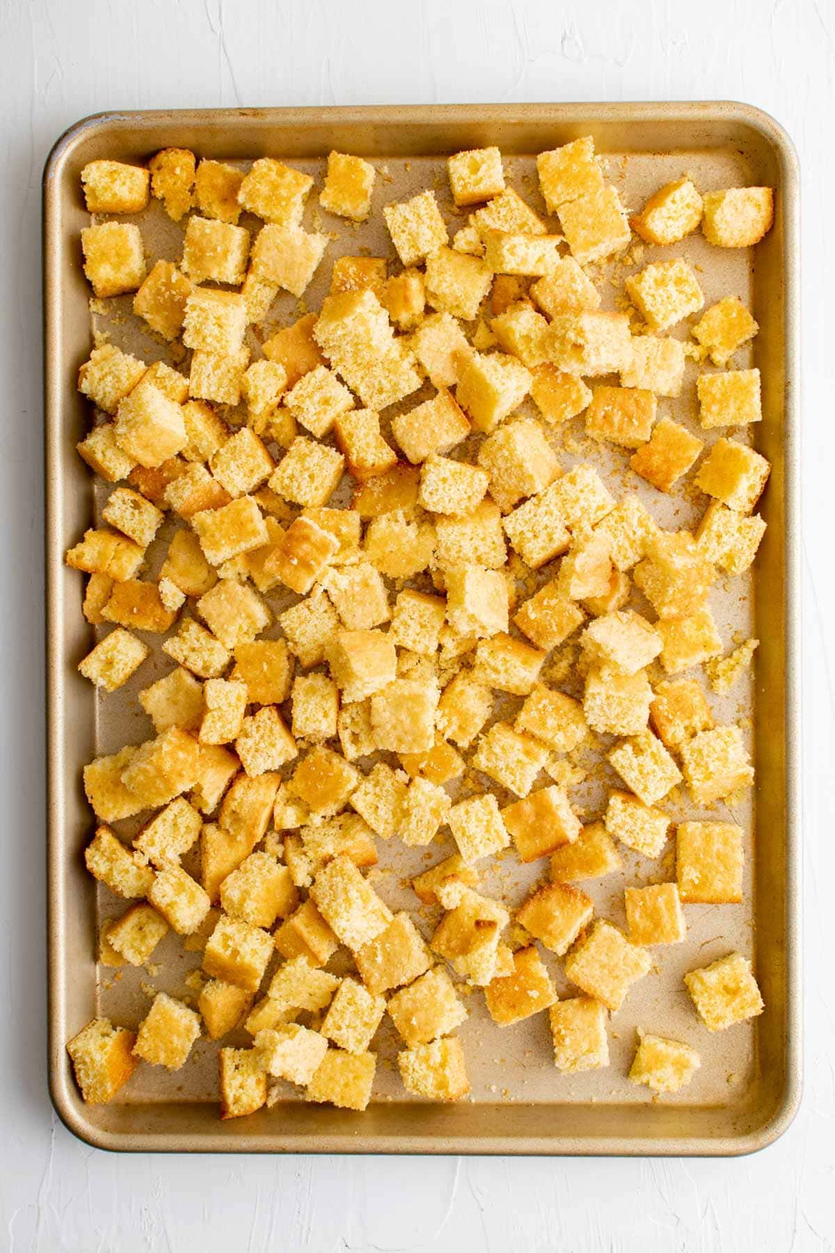 cubes of cornbread on a baking sheet