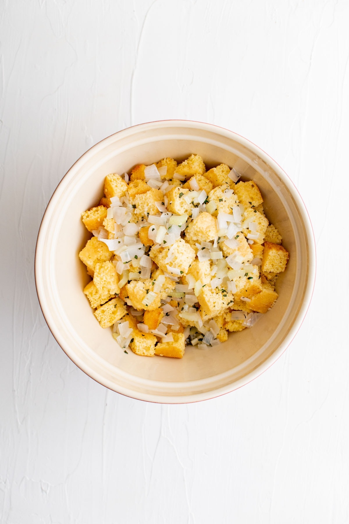 bowl of cornbread cubes with onions and herbs