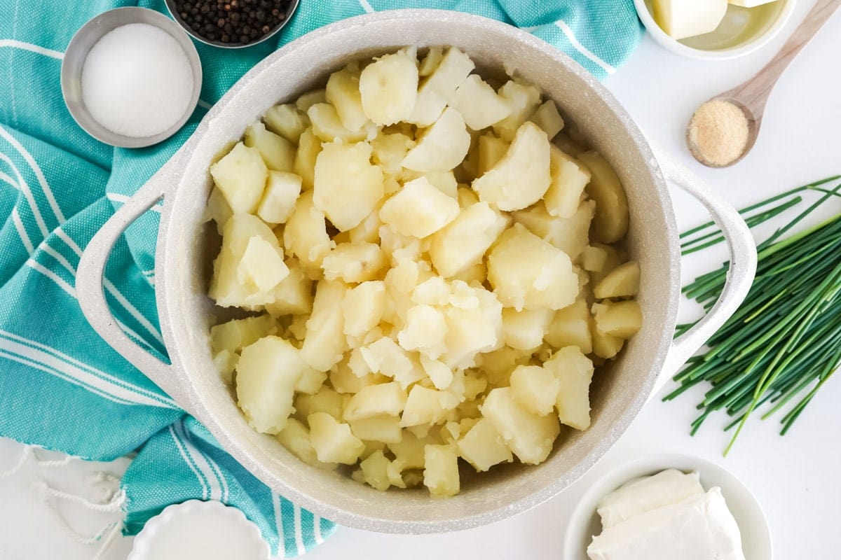 cooked diced potatoes in a white pot