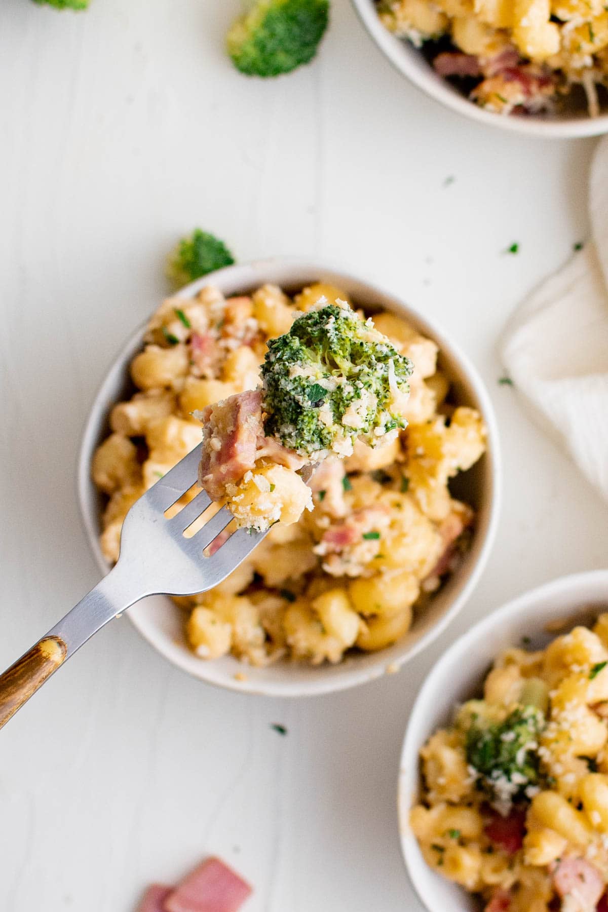 broccoli, ham and pasta on a fork