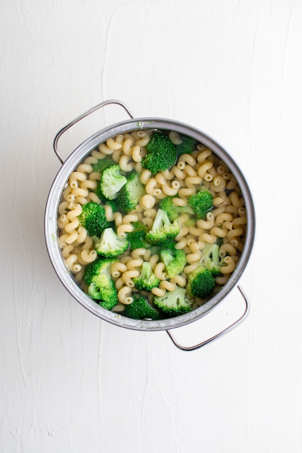 broccoli and pasta in a pot of water