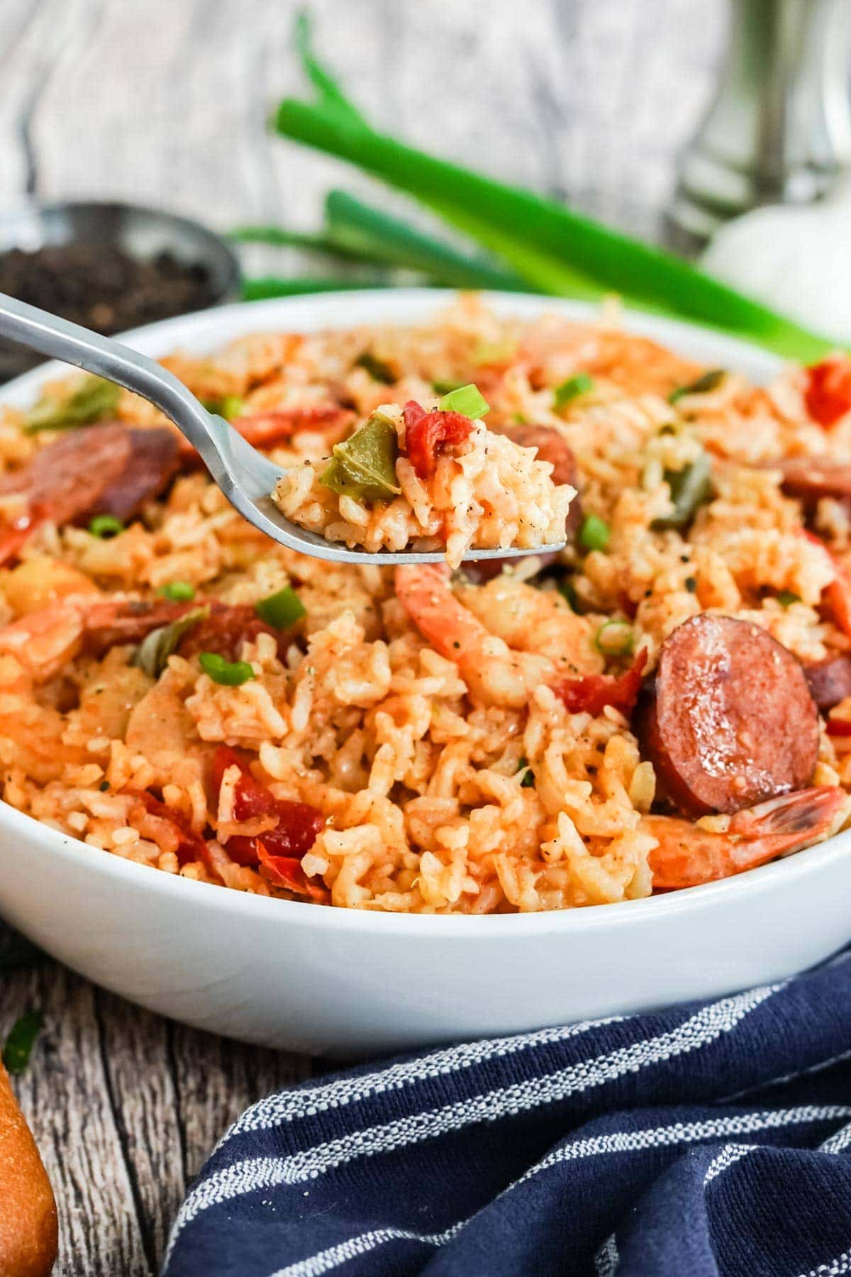 white bowl with cajun instant pot jambalaya and a fork