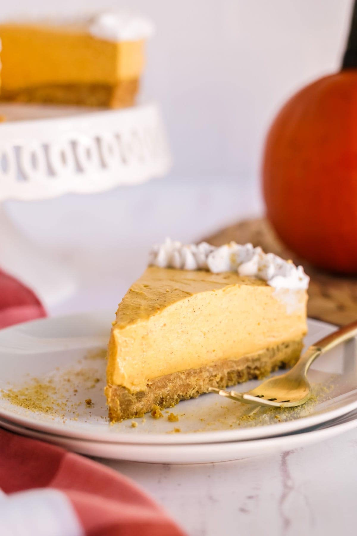 no bake pumpkin cheesecake slice on a plate with a fork