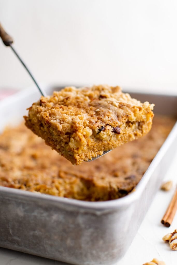 pumpkin dump cake in a pan with a spatula