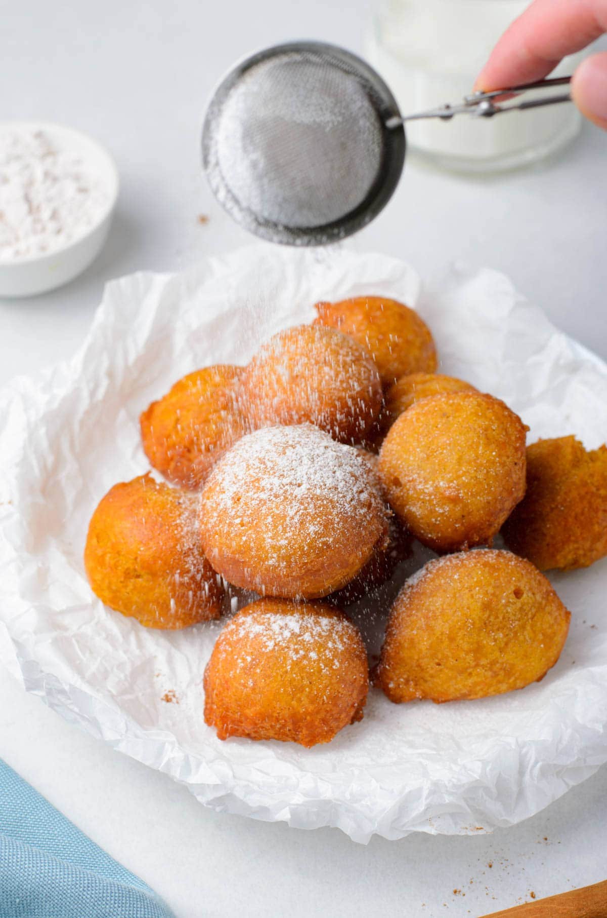 powdered sugar shaker over the fritters