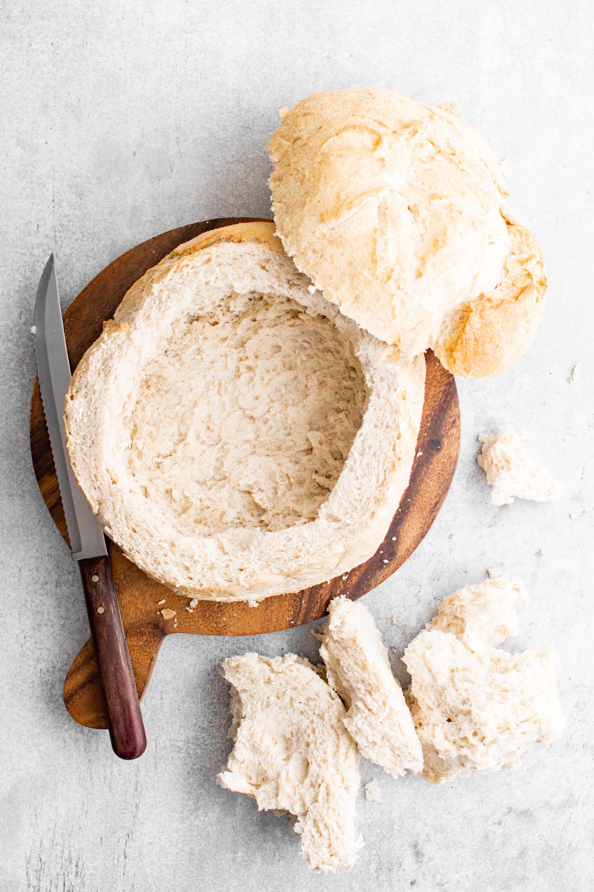 hollowed out bread bowl, cutting board and knife