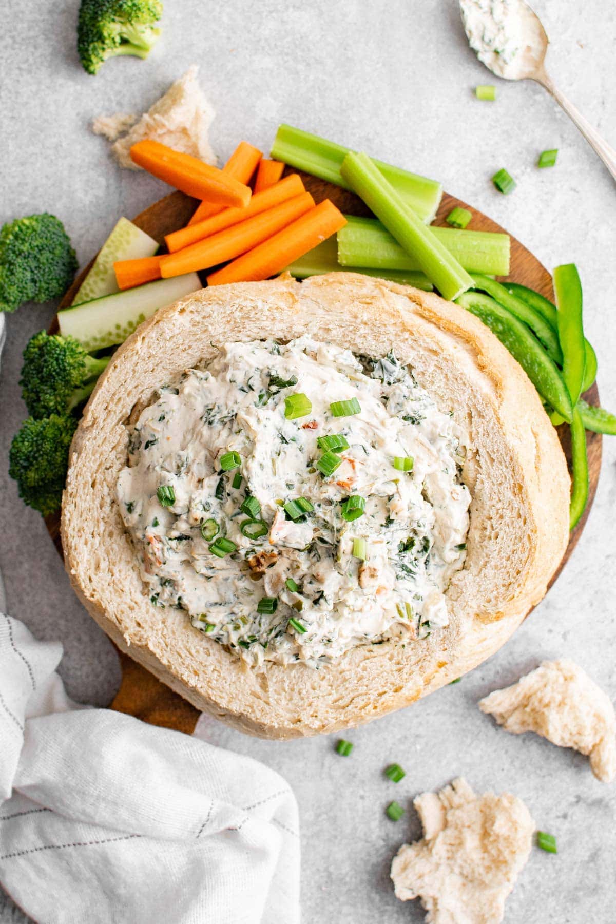 bread bowl with creamy spinach dip and veggies