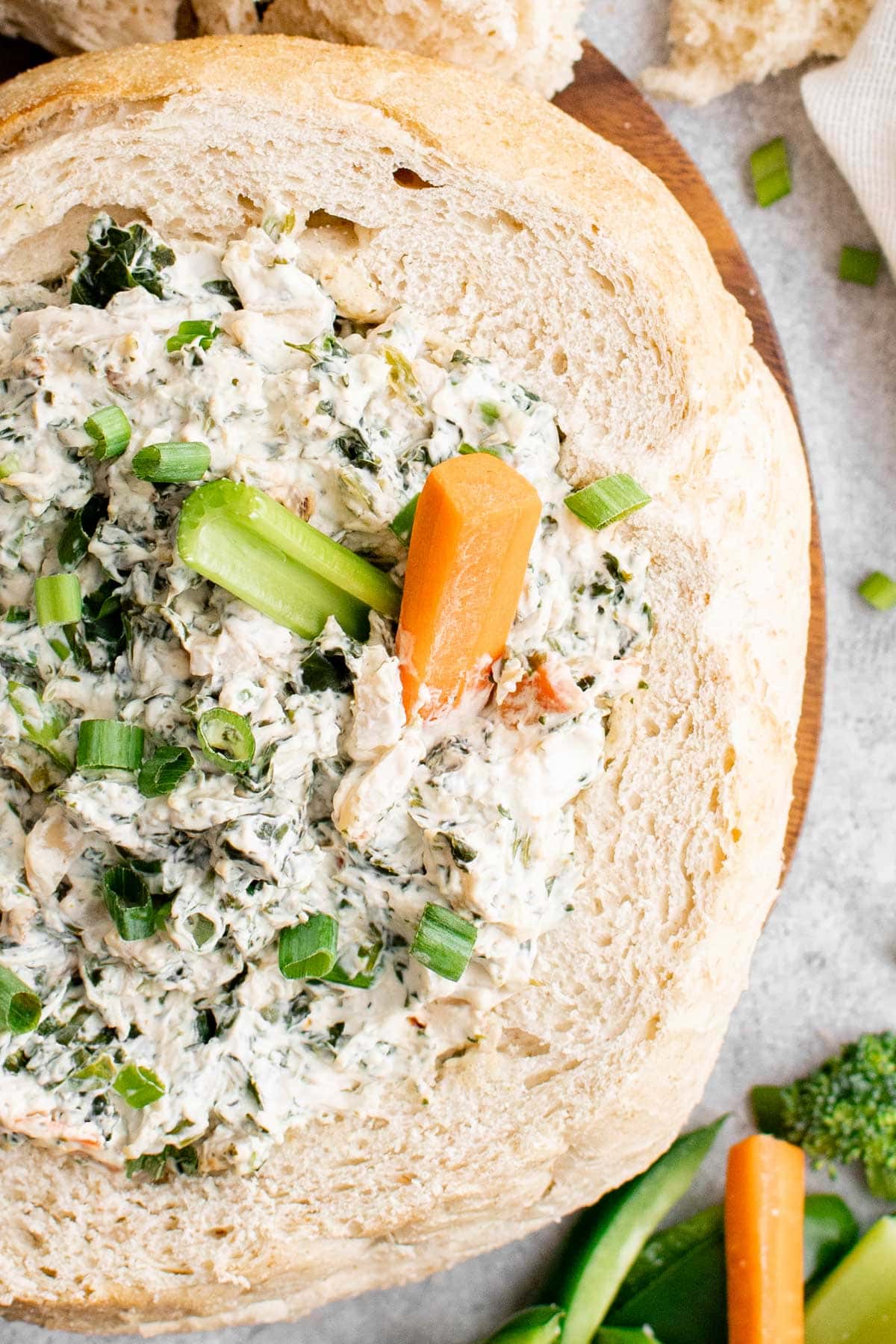 hollowed out loaf of bread filled with spinach dip