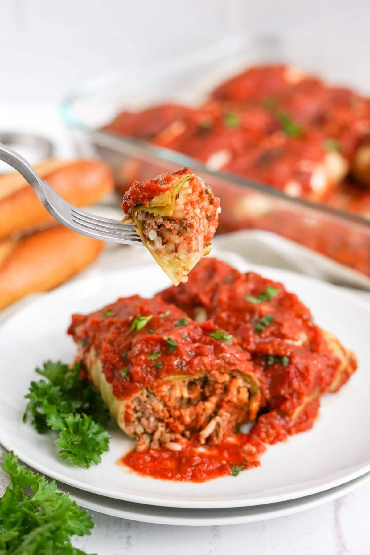 fork with a piece of a cabbage rolls on it