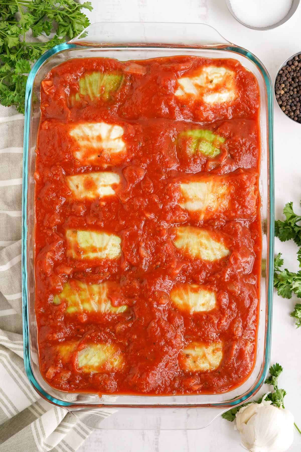 baking dish with rolled up cabbage and tomatoe sauce