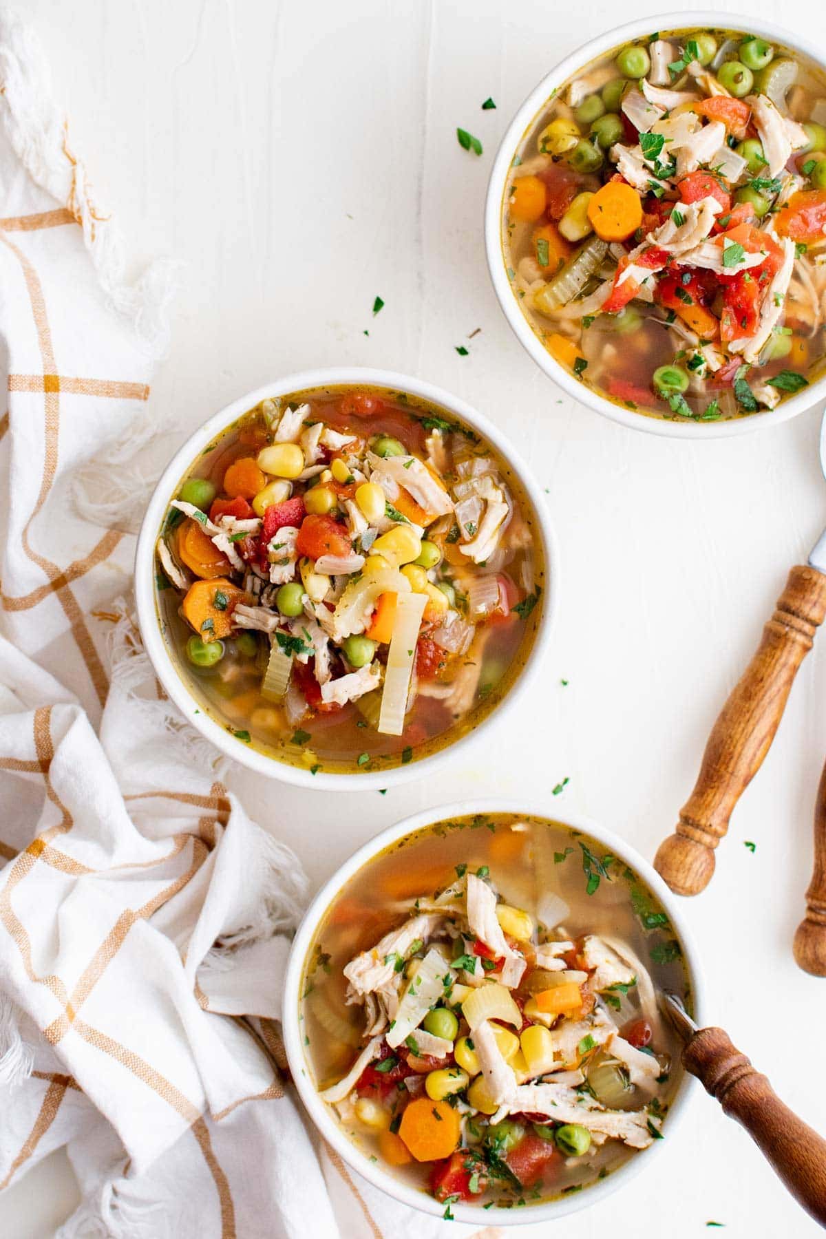 turkey veggie soup in white bowls