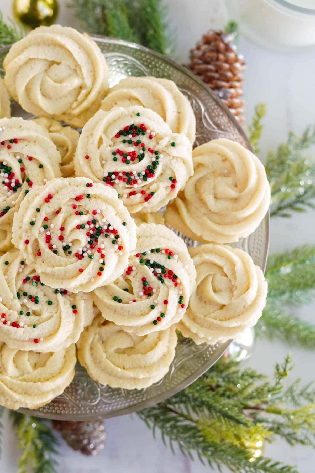 christmas butter cookies on a tray with pine branches