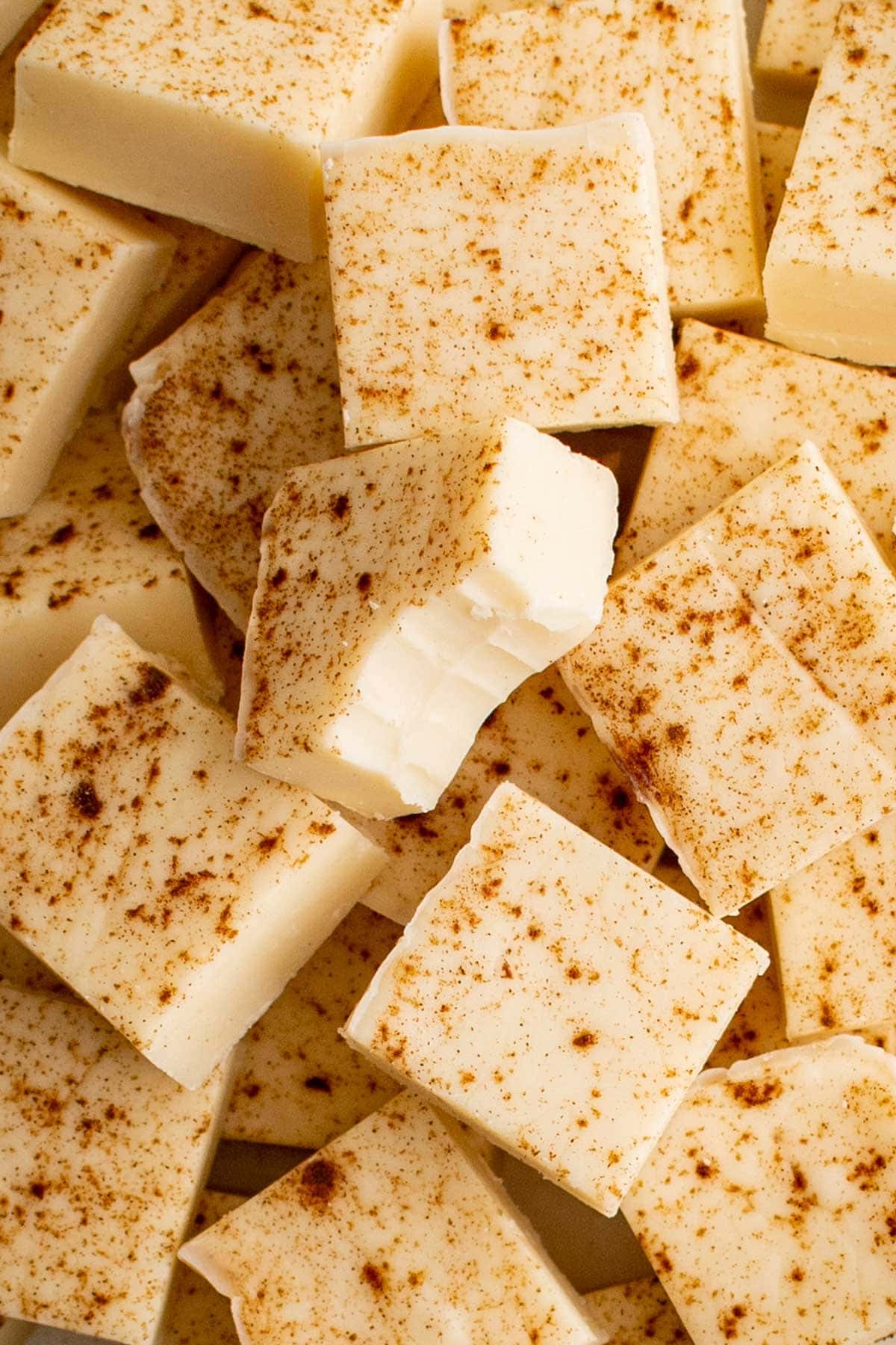small squares of white chocolate fudge with a bit taken out of one