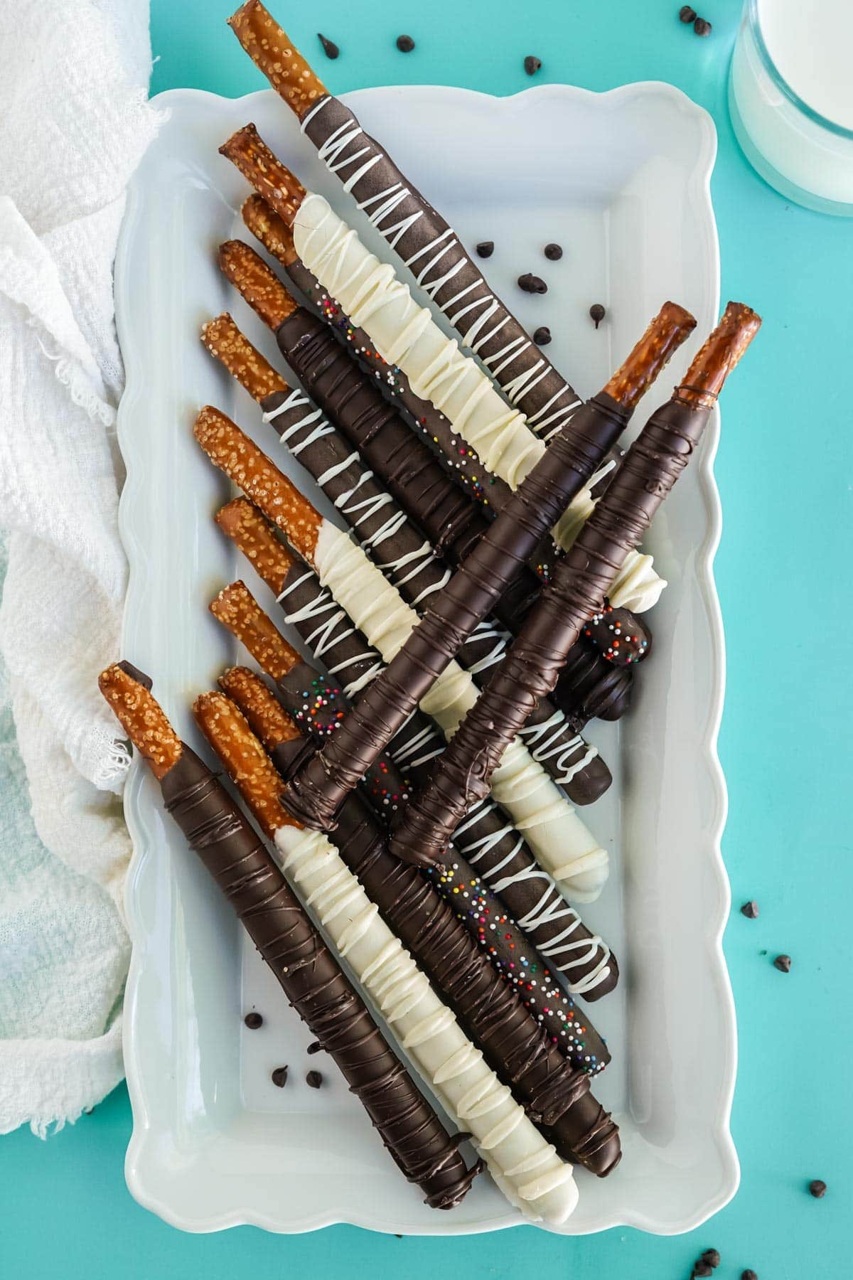 white platter with chocolate dipped pretzel rods