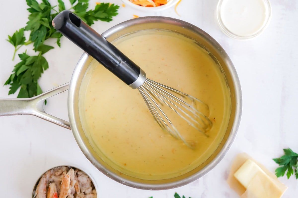 cheese sauce in a pan with a whisk