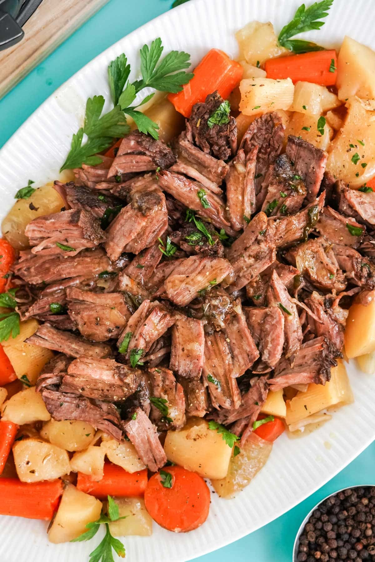 shredded pot roast, carrots and potatoes on a platter