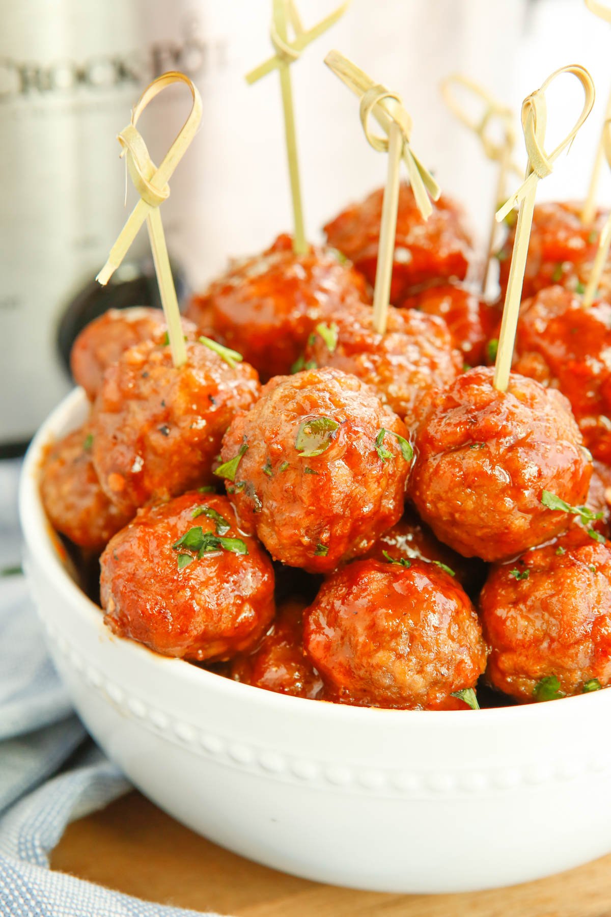 meatballs in a white bowl with toothpicks