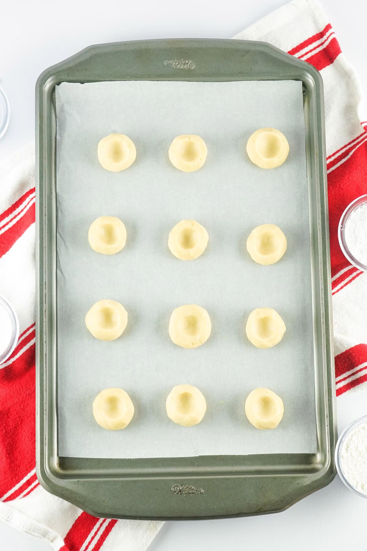 thumbprint cookies on a baking sheet