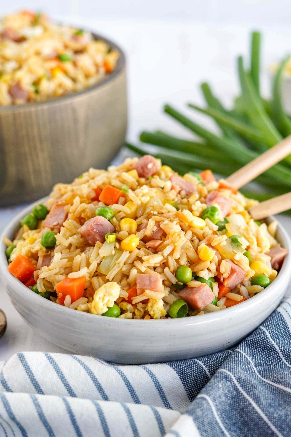 ham fried rice in a white bowl with chopsticks